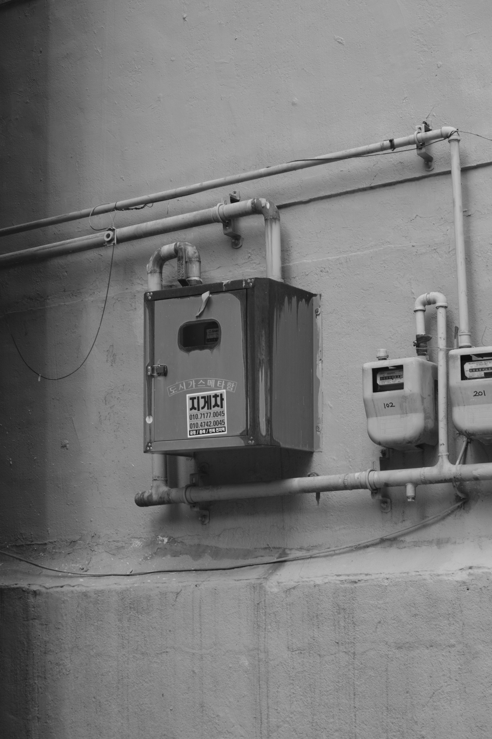 Real gas meters and pipework installed on an exterior utility wall