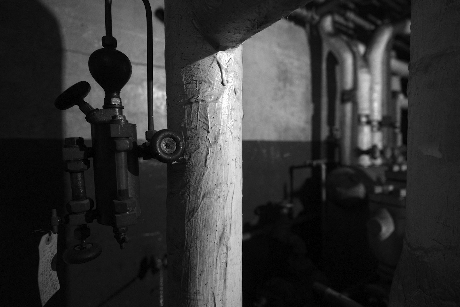 Real industrial mechanical room with pipes, valves, and utility infrastructure
